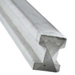 A closeup of a concrete slotted fence post