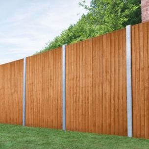 An image showing closeboard fence panels erected in garden with concrete fence posts.