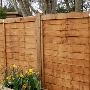 An image showing 2 overlap panels separated by a wooden fence post.